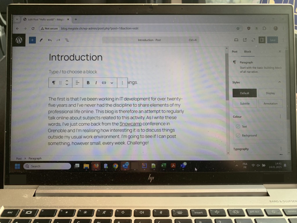 A picture of the laptop showing this blog post being typed